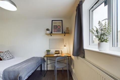 A cozy and well-maintained bedroom featuring a ...