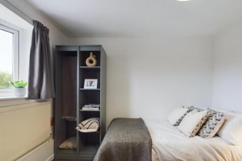 A cozy and well-maintained bedroom featuring a ...