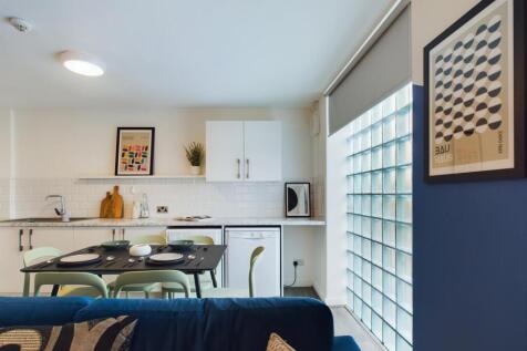 A bright and modern kitchen area featuring ampl...