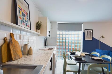 A modern and well-lit kitchen featuring a marbl...