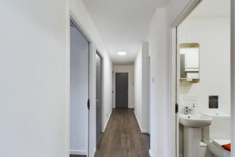 Bright, freshly painted hallway with modern woo...