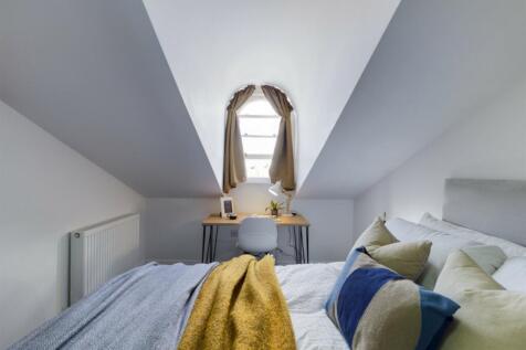 A cozy and well-lit double bedroom with a charm...