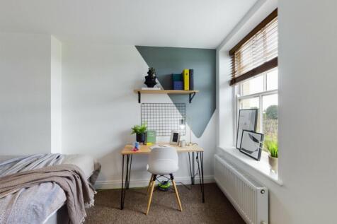 A stylish and clean double bedroom featuring a ...