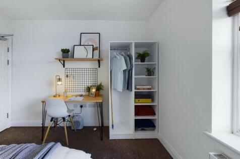 A bright and tidy double bedroom featuring a st...