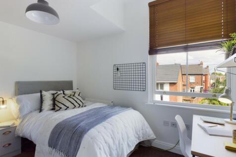 A bright and inviting double bedroom featuring ...