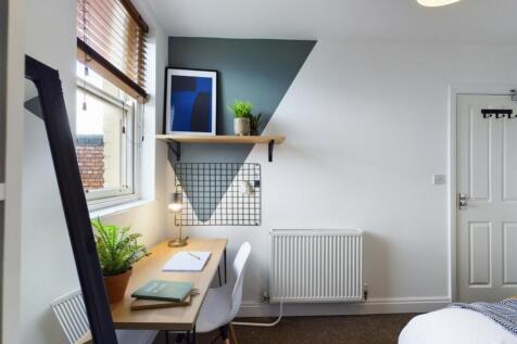 A bright and inviting double bedroom featuring ...