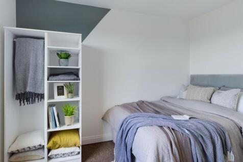 A beautifully arranged double bedroom with a co...