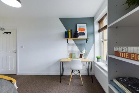 A bright and inviting double bedroom featuring ...