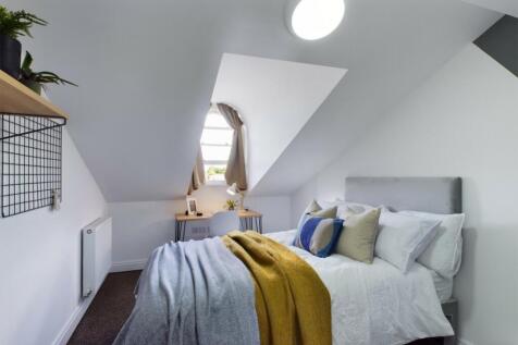 A bright and inviting double bedroom featuring ...