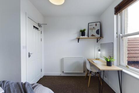 A bright and tidy double bedroom featuring a co...