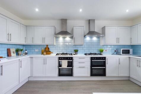 A modern and spacious kitchen featuring sleek c...
