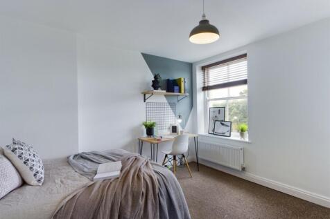 A bright and inviting double bedroom featuring ...
