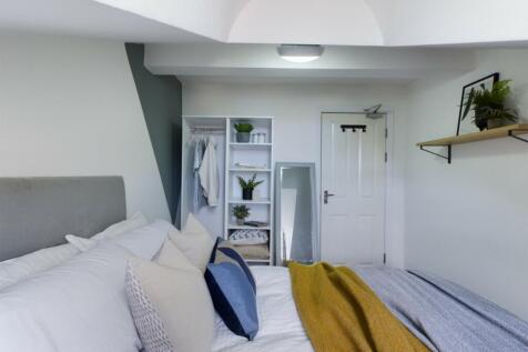 A bright and inviting double bedroom with moder...