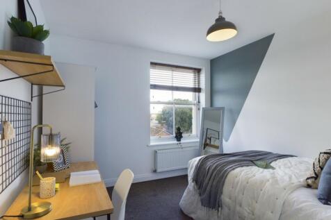 A stylish and well-lit double bedroom featuring...