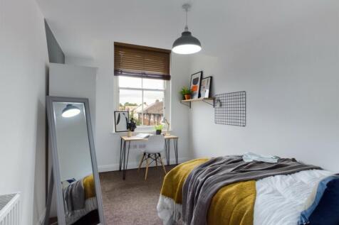 A bright and inviting double bedroom featuring ...