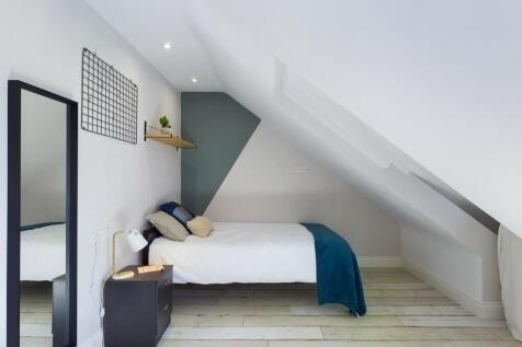A bright and stylish double bedroom featuring a...