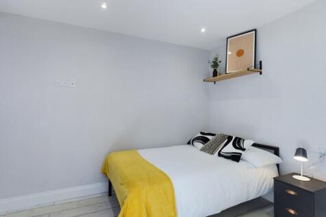 A bright and inviting master bedroom featuring ...