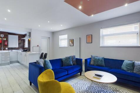 A modern and spacious living room with comforta...