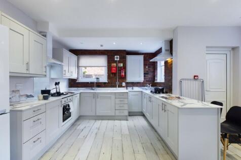 Bright and spacious kitchen with modern white c...