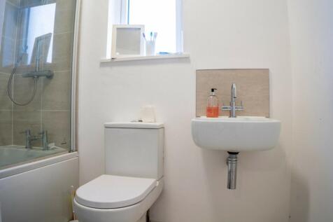 A clean and modern bathroom featuring a stylish...
