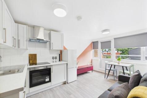 Bright and modern living room featuring large w...