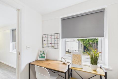 A bright, tidy exterior shot of the property sh...