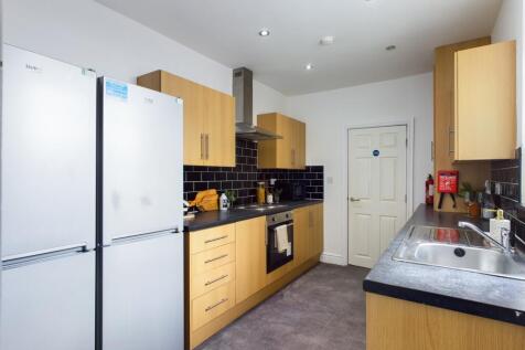 A modern and clean kitchen with ample storage a...