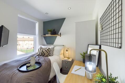 A bright and inviting double bedroom featuring ...