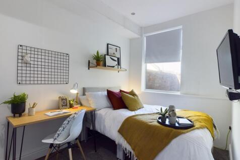 A bright and stylish double bedroom featuring m...