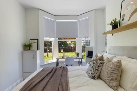 A bright and inviting double bedroom featuring ...