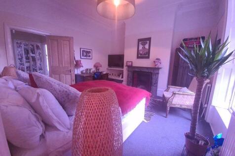 A bright and spacious living room featuring com...