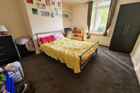 Spacious and well-lit master bedroom featuring ...