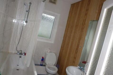 A well-maintained bathroom featuring a bathtub,...