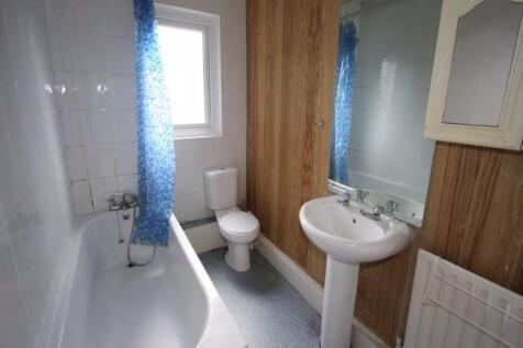 A spacious and clean bathroom featuring a large...