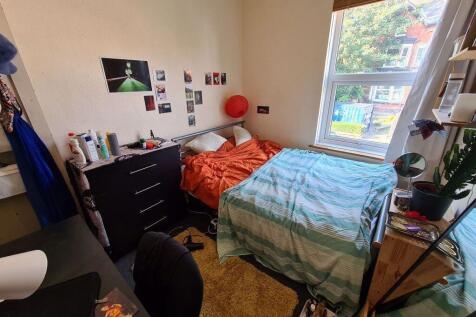 A bright and cozy bedroom featuring an orange b...