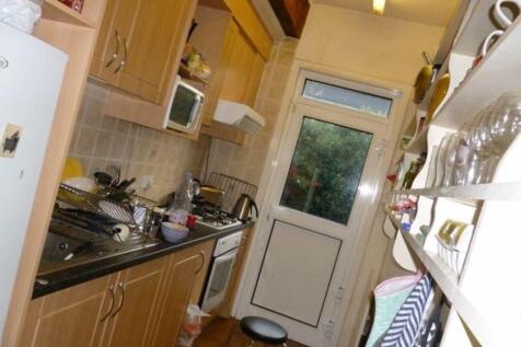 A well-maintained kitchen with wooden cabinets,...