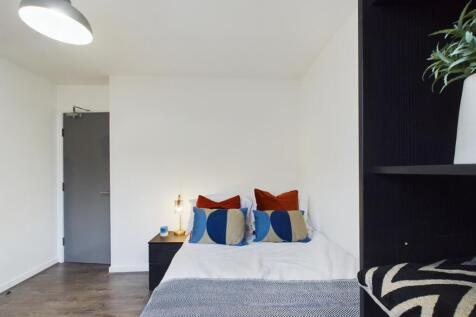 A bright and inviting double bedroom featuring ...