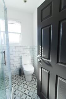 A bright and modern bathroom featuring a stylis...