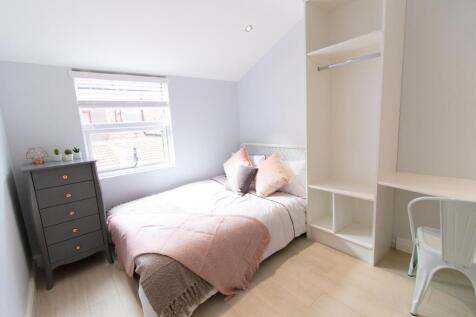 A stylish and well-lit double bedroom featuring...