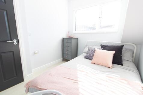 A bright and inviting double bedroom with styli...