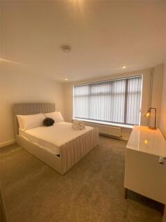 A modern, tidy bedroom featuring a comfortable ...