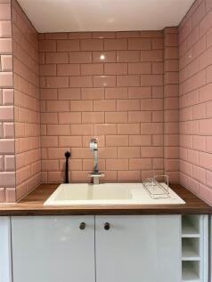 A clean and functional bathroom with a spacious...