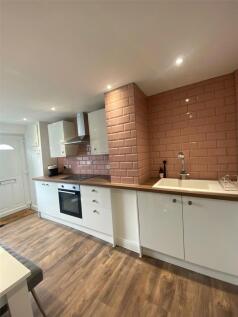A modern, well-maintained kitchen featuring whi...