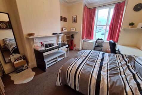 A spacious and inviting master bedroom featurin...