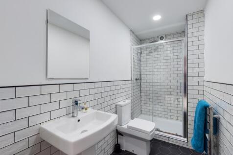 A modern and stylish bathroom featuring sleek t...