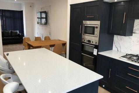 Modern, well-maintained kitchen with sleek dark...