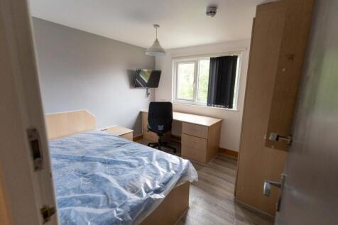 Bright and welcoming bedroom with a large windo...