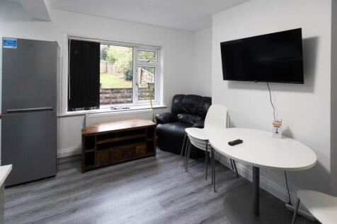 A bright, welcoming living room featuring a lar...