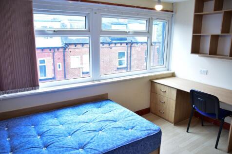 Bright and tidy bedroom featuring a large windo...