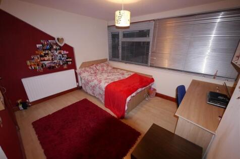 Cozy single bedroom featuring a comfortable bed...